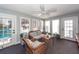 Enclosed sunroom with wicker furniture and view of the outdoor pool and backyard at 106 Caveson Dr, Summerville, SC 29483