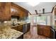 Beautiful kitchen features wood cabinets, granite countertops, and stainless steel appliances, adjacent to dining area at 108 Nightingale Manor, North Charleston, SC 29418