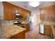 Well-equipped kitchen features stainless steel appliances, granite countertops, wood cabinets, and stylish backsplash at 108 Nightingale Manor, North Charleston, SC 29418