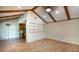 Spacious living room with vaulted ceiling, exposed beams, built-in shelving and wood-look floors at 108 Nightingale Manor, North Charleston, SC 29418