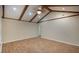 Open living room with vaulted ceiling, wood beams, and wood-look floors offering a cozy atmosphere at 108 Nightingale Manor, North Charleston, SC 29418