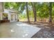 A backyard patio with double doors leading into the house in a backyard setting with scattered trees at 108 Nightingale Manor, North Charleston, SC 29418