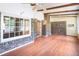 Inviting sunroom with wood floors, exposed beams, brick accents, and many windows for natural light at 108 Nightingale Manor, North Charleston, SC 29418