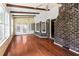 Bright sunroom features hardwood floors, ceiling fans, and large windows for ample natural light and backyard views at 108 Nightingale Manor, North Charleston, SC 29418