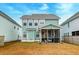 Backyard showcasing a screened-in porch and a grassy yard, offering a place for outdoor activities at 109 Forest Springs Rd, Moncks Corner, SC 29461