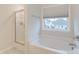 Bright bathroom featuring a large tub with shower and a window, creating a spa-like experience at 109 Forest Springs Rd, Moncks Corner, SC 29461