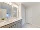 Bright bathroom features double sink vanity with gray cabinets, and a large mirror, providing a functional space at 109 Forest Springs Rd, Moncks Corner, SC 29461