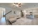 Bright, open-concept living room featuring hardwood floors, stairs, and a modern ceiling fan at 109 Forest Springs Rd, Moncks Corner, SC 29461