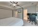 Bright primary bedroom featuring a tray ceiling, ceiling fan, and a dedicated workspace at 109 Forest Springs Rd, Moncks Corner, SC 29461