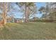 Expansive backyard featuring a lush lawn, mature trees, and a wooden fence, perfect for outdoor activities and privacy at 111 Summit Ave, Goose Creek, SC 29445