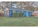 Charming single-story home with blue brick, manicured lawn, and a vibrant turquoise front door at 111 Summit Ave, Goose Creek, SC 29445
