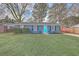Charming single-story home with blue brick and a bright turquoise front door, complemented by a lush lawn at 111 Summit Ave, Goose Creek, SC 29445