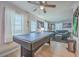 Pool table in an entertainment area of the home with an adjacent living room and access to the backyard at 111 Summit Ave, Goose Creek, SC 29445