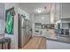 Well-lit kitchen with stainless steel refrigerator and laminate floors, offering a practical and stylish cooking environment at 111 Summit Ave, Goose Creek, SC 29445