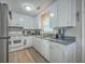 Bright kitchen with white cabinetry, stainless steel appliances, and ample counter space, ideal for cooking and meal preparation at 111 Summit Ave, Goose Creek, SC 29445