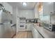 Functional kitchen with white cabinets, stainless steel appliances, and laminate floors, providing a clean and efficient space at 111 Summit Ave, Goose Creek, SC 29445