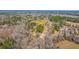 Expansive aerial view of property showcasing surrounding wooded area and the adjacent neighborhood at 117 Roberts Rd, Summerville, SC 29483