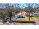Aerial view of charming blue house, with the cleared lot behind the home surrounded by trees at 117 Roberts Rd, Summerville, SC 29483