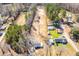 Aerial shot of home with surrounding properties and a large cleared lot in the back at 117 Roberts Rd, Summerville, SC 29483