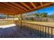 A view from the wooden back deck overlooking the backyard and fence, bathed in bright sunlight under a blue sky at 117 Roberts Rd, Summerville, SC 29483