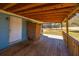 Covered back porch with wooden flooring and an outdoor shower at 117 Roberts Rd, Summerville, SC 29483