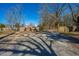 The spacious gravel backyard features a wooden privacy fence and gated driveway at 117 Roberts Rd, Summerville, SC 29483