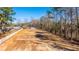 Spacious cleared lot ready for construction, with neighboring homes and mature trees at 117 Roberts Rd, Summerville, SC 29483