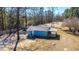 Quaint blue home showcasing a covered back deck, nestled in a wooded landscape at 117 Roberts Rd, Summerville, SC 29483