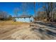 This is the blue exterior of a beautiful house, with a cozy wooden porch, surrounded by trees, and a sunny sky above at 117 Roberts Rd, Summerville, SC 29483