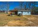 The backyard of this house features a deck, a blue exterior, and a well-maintained yard with a blue sky above at 117 Roberts Rd, Summerville, SC 29483