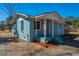 Charming bungalow with a cozy porch and a colorful flower bed at 117 Roberts Rd, Summerville, SC 29483