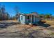 Charming blue bungalow featuring a well-manicured lawn and gravel driveway at 117 Roberts Rd, Summerville, SC 29483