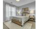 Cozy bedroom features plush rug, neutral walls, plenty of natural light, and a comfortable queen bed at 1225 Blakeway St # 1104, Daniel Island, SC 29492