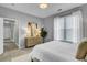 Bright bedroom featuring neutral walls, light wood dresser, art, and lots of natural light at 1225 Blakeway St # 1104, Daniel Island, SC 29492