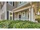 Inviting entryway with green shrubs and a covered porch to greet guests with charm at 1225 Blakeway St # 1104, Daniel Island, SC 29492