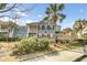 Charming two-story condo with a balcony and tropical landscaping adding to its curb appeal at 1225 Blakeway St # 1104, Daniel Island, SC 29492