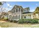 Charming two-story home showcasing a covered front porch and lush landscaping at 1225 Blakeway St # 1104, Daniel Island, SC 29492