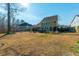 Large, grassy backyard featuring a patio, outdoor seating, trees, and privacy fence at 136 Stagecoach Ln, Summerville, SC 29483