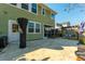 Spacious backyard patio with green siding, covered grill, pergola swing, and an outdoor entertainment area at 136 Stagecoach Ln, Summerville, SC 29483