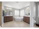 This bathroom boasts a large soaking tub between two vanities and large windows at 136 Stagecoach Ln, Summerville, SC 29483