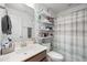 Small bathroom features a shower-tub combo, a sink and a shelving unit at 136 Stagecoach Ln, Summerville, SC 29483