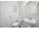 Cozy powder room featuring pedestal sink, framed mirror, neutral paint color, and clean lines at 136 Stagecoach Ln, Summerville, SC 29483