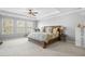 Spacious bedroom with a tray ceiling, soft carpet, large windows, and a king-size bed at 136 Stagecoach Ln, Summerville, SC 29483