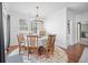 Bright dining room features hardwood floors, large windows, and stylish chandelier over the glass table at 136 Stagecoach Ln, Summerville, SC 29483