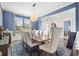 Traditional dining room with a wood table, upholstered chairs, and a modern chandelier at 136 Stagecoach Ln, Summerville, SC 29483