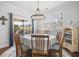 Sun-filled dining area featuring hardwood flooring, a glass table, and sliding doors to the backyard at 136 Stagecoach Ln, Summerville, SC 29483