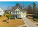 Charming two-story home with green siding, well-manicured lawn, and two car garage at 136 Stagecoach Ln, Summerville, SC 29483