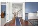 View of foyer featuring hardwood floors, blue accent wall, and a view of living spaces at 136 Stagecoach Ln, Summerville, SC 29483
