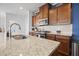 Kitchen featuring a granite island, stainless steel appliances, and dark wood cabinets at 136 Stagecoach Ln, Summerville, SC 29483