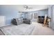 Bright living room featuring a large sectional sofa, area rug, and an art easel by the window at 136 Stagecoach Ln, Summerville, SC 29483